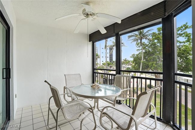 Sunroom / solarium featuring a ceiling fan, tile patterned flooring, and plenty of natural light | Image 33