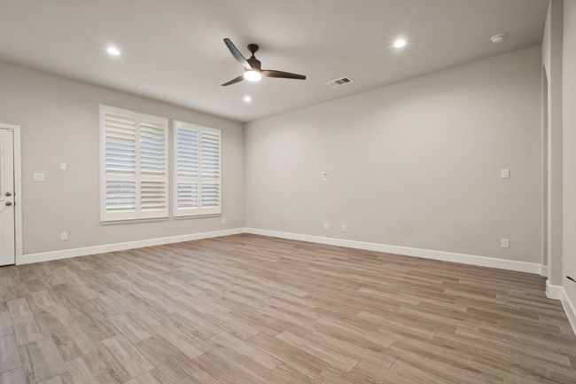 Empty room featuring a ceiling fan, recessed lighting, light wood-style floors, and a smoke detector | Image 7