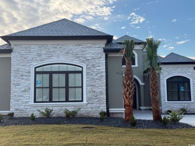 View of property exterior featuring a lawn | Image 1