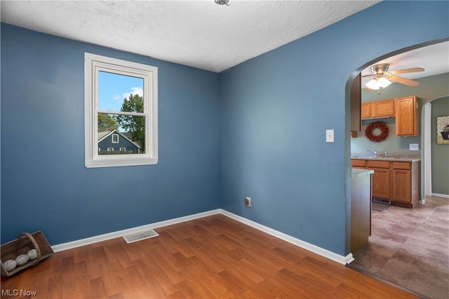 Empty room with light hardwood floors and ceiling fan | Image 14
