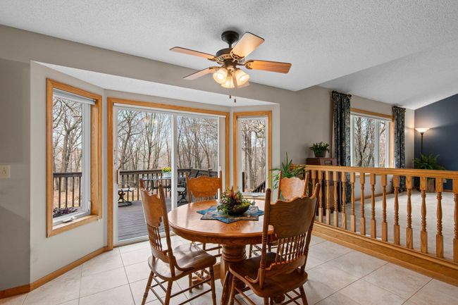 Informal dining room with walkout to deck. Note the newer LVT adding a beautiful tile-look to the floor | Image 9