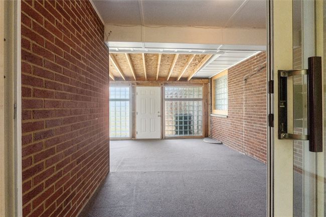 bonus room off of the primary bedroom that leads to outside | Image 21