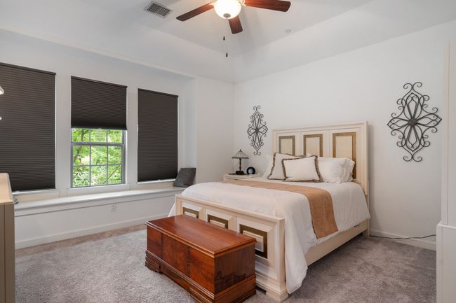 Bedroom with carpet flooring and a ceiling fan | Image 14