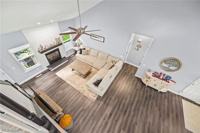 Living room featuring high vaulted ceiling, ceiling fan, and dark hardwood / wood-style flooring | Image 25