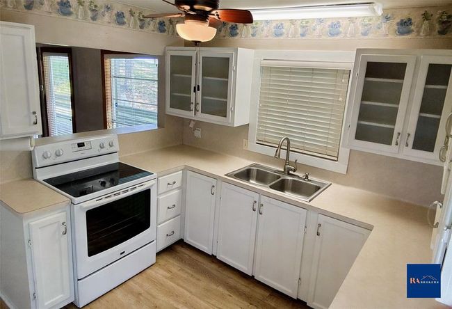 Charming kitchen with abundant storage, featuring a refrigerator and two spacious pantries. | Image 15