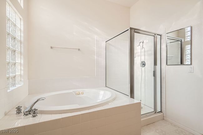 Bathroom featuring a shower stall and a garden tub | Image 19