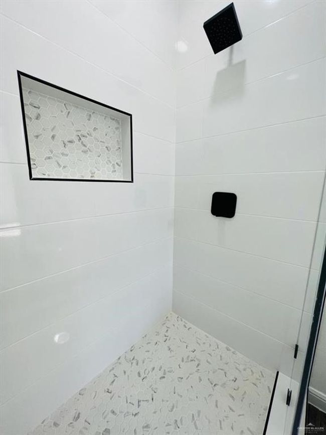 Bathroom featuring a tile shower | Image 18