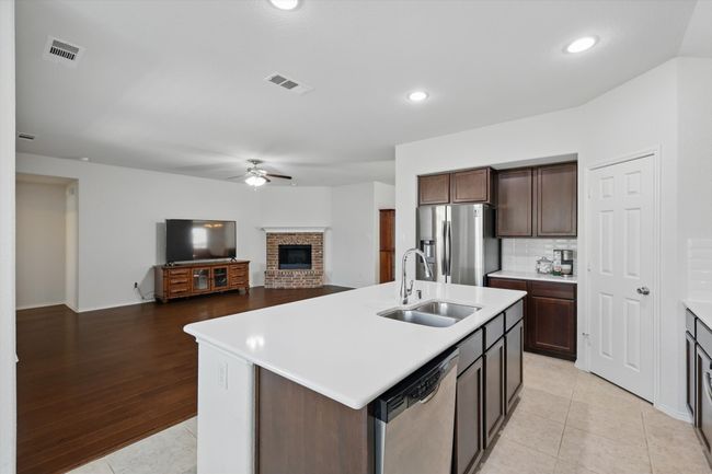 Kitchen with visible vents, appliances with stainless steel finishes, ceiling fan, and a sink | Image 25