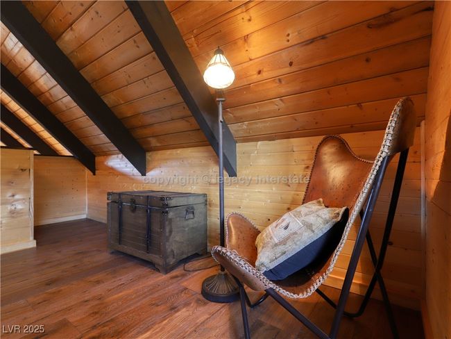 Sitting room featuring vaulted ceiling with beams, wood walls, wood ceiling, and hardwood / wood-style floors | Image 28
