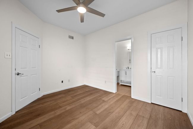 Bedroom featuring wood finished floors, baseboards, and ceiling fan | Image 10