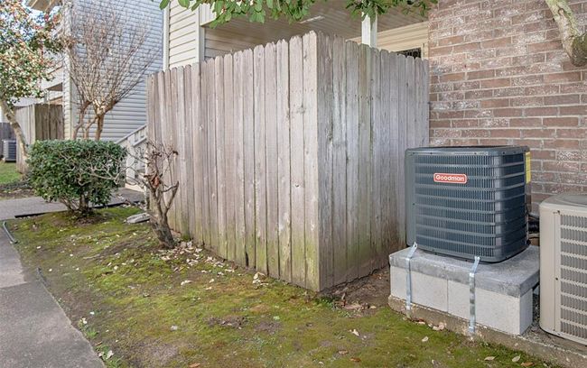 The 1.5 ton Goodman air conditioning unit sits on concrete blocks. Air handler, condenser and vent covers were installed 2025. | Image 4