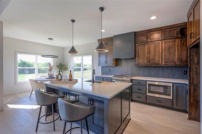 THE KITCHEN ISLAND HAS PLENTY OF FUNCTIONAL AND ATTRACTIVE STORAGE | Image 3