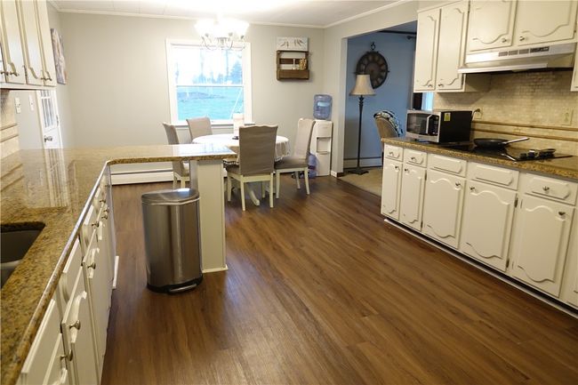 Fully equipped kitchen with abundant countertop space and cabinetry | Image 6