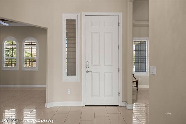 Entrance foyer featuring baseboards, a ceiling fan, and light tile patterned flooring | Image 5