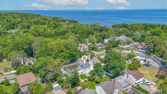 Aerial view of property and surrounding area featuring nearby suburban area and a nearby body of water | Image 6