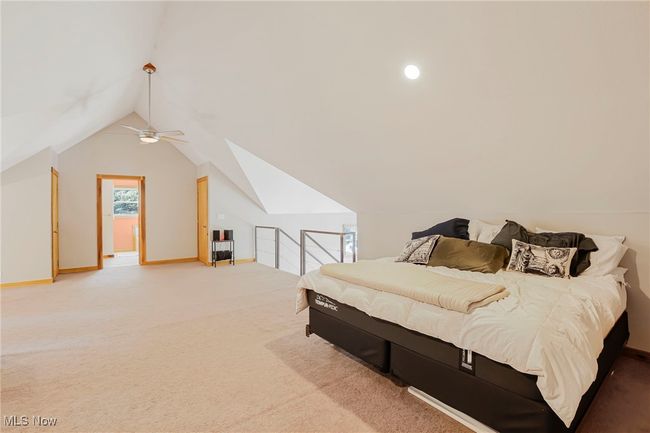 Bedroom with carpet, vaulted ceiling, and a ceiling fan | Image 35