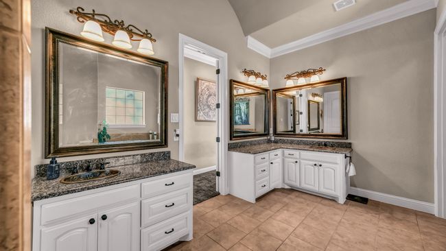 Bathroom with crown molding, visible vents, baseboards, two vanities, and a sink | Image 25