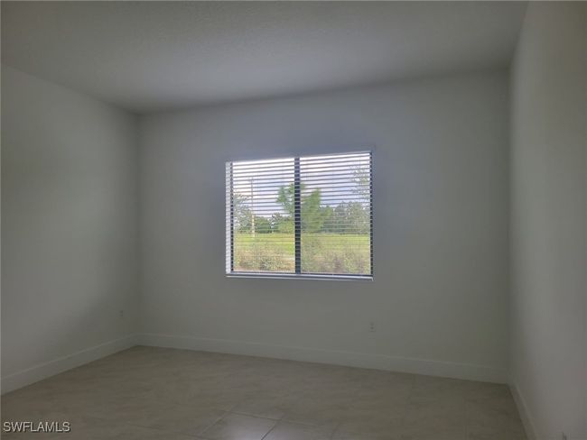 Empty room with baseboards and light tile patterned floors | Image 10