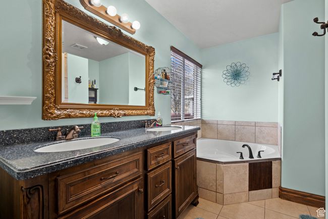 Full bathroom with tile patterned floors, a sink, double vanity, and a bath | Image 13