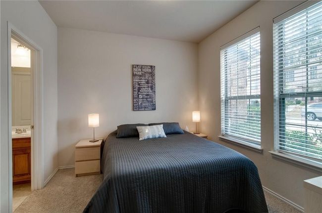 Carpeted bedroom featuring multiple windows and sink | Image 12