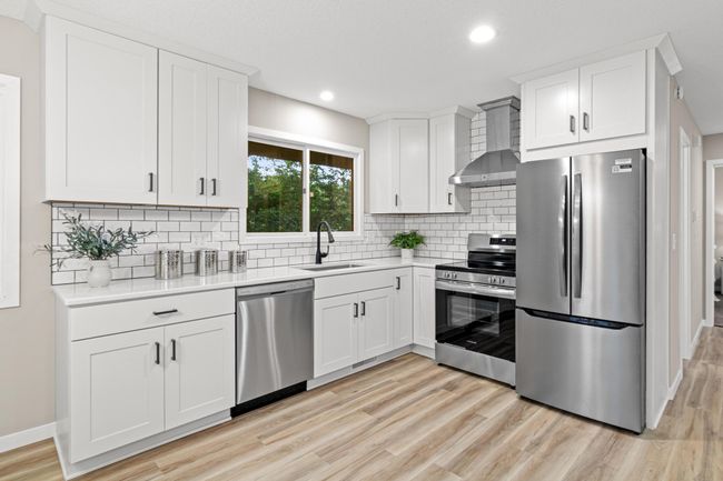 Slow close drawers, crown molding, oversized sink, lazy susan and quartz countertops are all highlights of this amazing kitchen area! There is even a pantry for extra storage at the top of the stairs. | Image 8