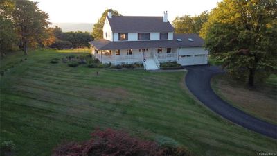 View of front of house featuring a porch and a front yard | Image 1