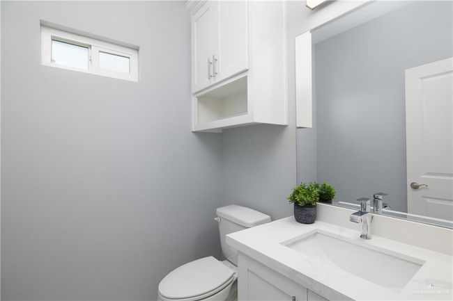 Half bathroom featuring vanity and toilet | Image 14