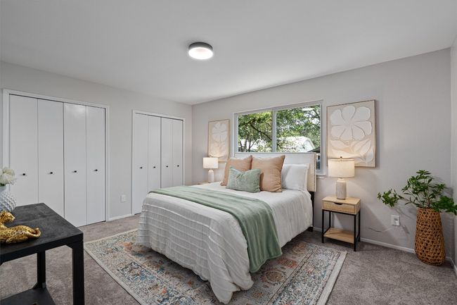 Bedroom with multiple closets and carpet flooring | Image 12