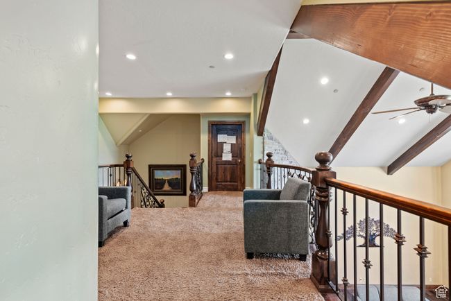 Interior space with an upstairs landing, ceiling fan, recessed lighting, and carpet | Image 42