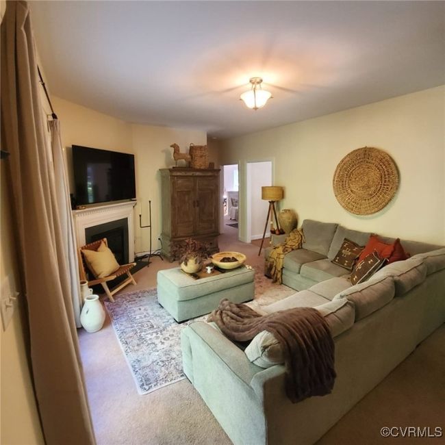 Living area with carpet floors and a fireplace | Image 19