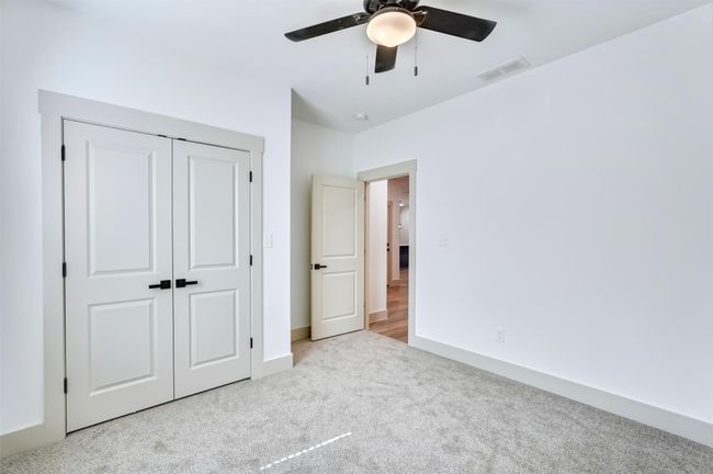 Unfurnished bedroom featuring carpet, a closet, a ceiling fan, visible vents, and baseboards | Image 19