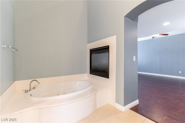 Bathroom featuring a tub with jets, tile patterned floors, and baseboards | Image 29