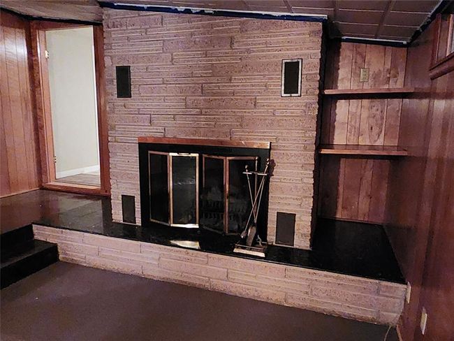 Details featuring a stone fireplace | Image 6