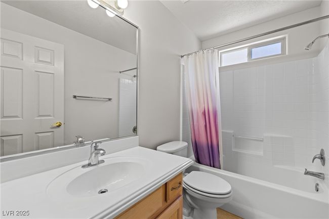 Bathroom featuring vanity, shower / bath combination with curtain, and a textured ceiling | Image 32