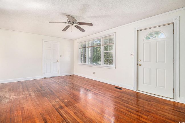 Entrance foyer featuring hardwood / wood-style floors, a ceiling fan, and a textured ceiling | Image 6