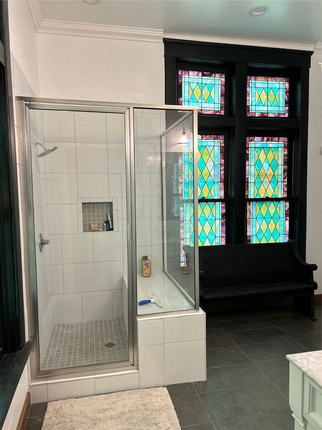 Bathroom featuring a stall shower, dark tile patterned floors, and vanity | Image 14