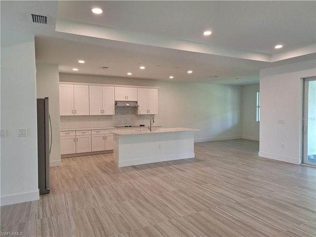 Gorgeous kitchen and casual dining room combo featuring Viatera quartz countertops and soft-close cabinets and drawers | Image 5
