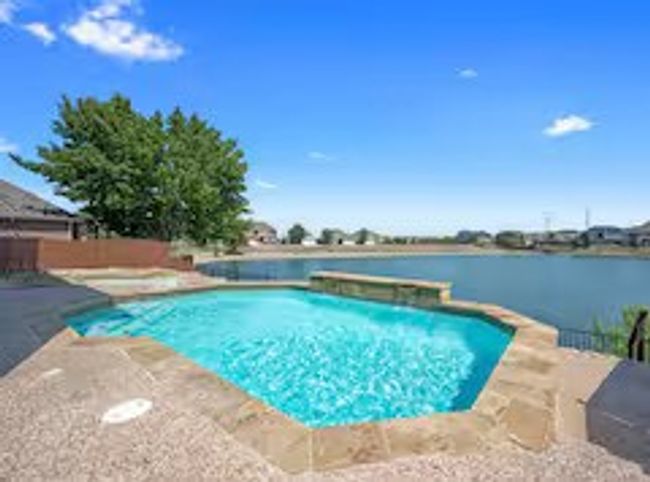 View of swimming pool with a water view and a patio | Image 19
