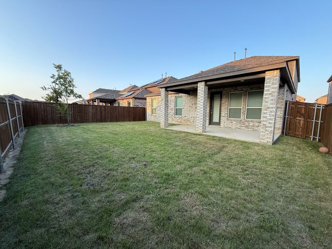 Back of house featuring a patio, roof with shingles, and brick siding | Image 22