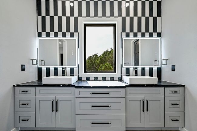 Featuring three custom designed luxury designer bathrooms including this private primary ensuite bath with a dual vanity. | Image 5