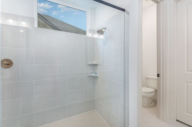 Bathroom featuring tiled shower and tile patterned floors | Image 31