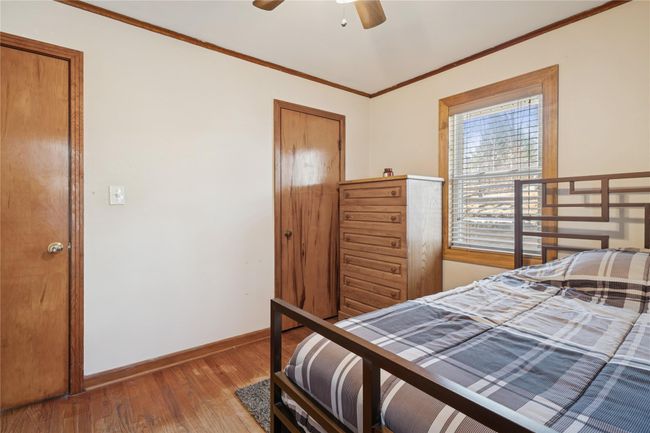 Bedroom with a ceiling fan, crown molding, wood finished floors, and baseboards | Image 30