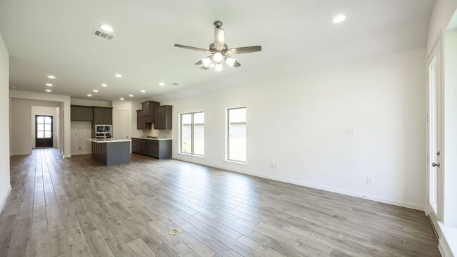 Unfurnished living room with ceiling fan, light wood-style floors, recessed lighting, and baseboards | Image 7