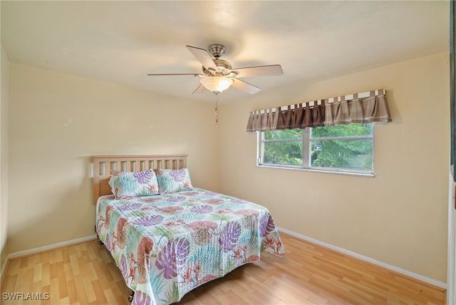 Bedroom with light hardwood / wood-style flooring, ceiling fan, and ensuite bathroom | Image 20