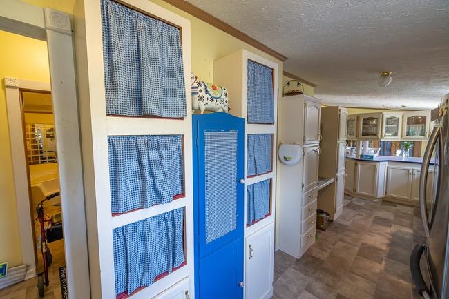 Hallway with ornamental molding and a textured ceiling | Image 4