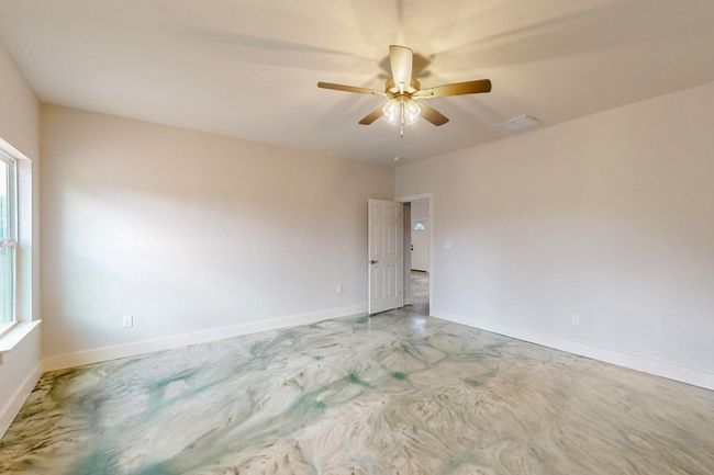 Unfurnished room with ceiling fan and concrete floors | Image 32