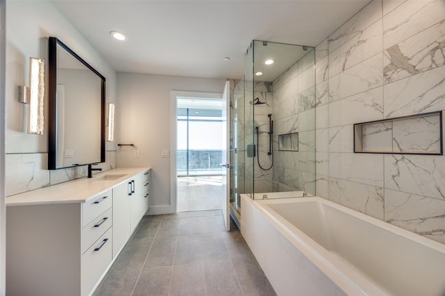 Bathroom with vanity, tile patterned flooring, and shower with separate bathtub | Image 7