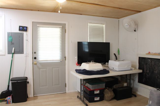 Office area with electric panel and wood finished floors | Image 9