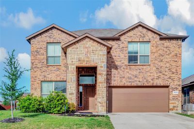 Front of property with a front yard, a garage, and central AC unit | Image 1