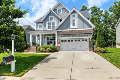 Craftsman inspired home with a garage, covered porch, and a front yard | Image 2